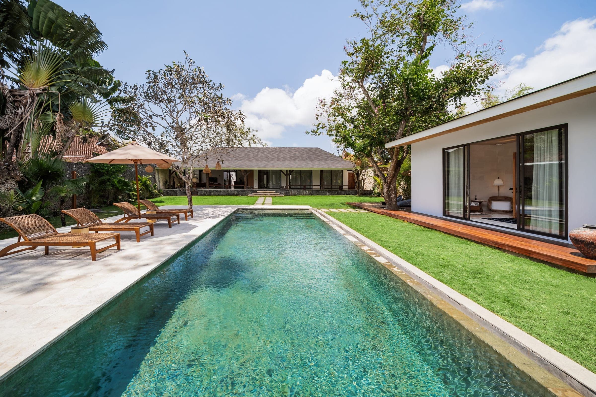 The pool and tropical lawn at Villa Timora